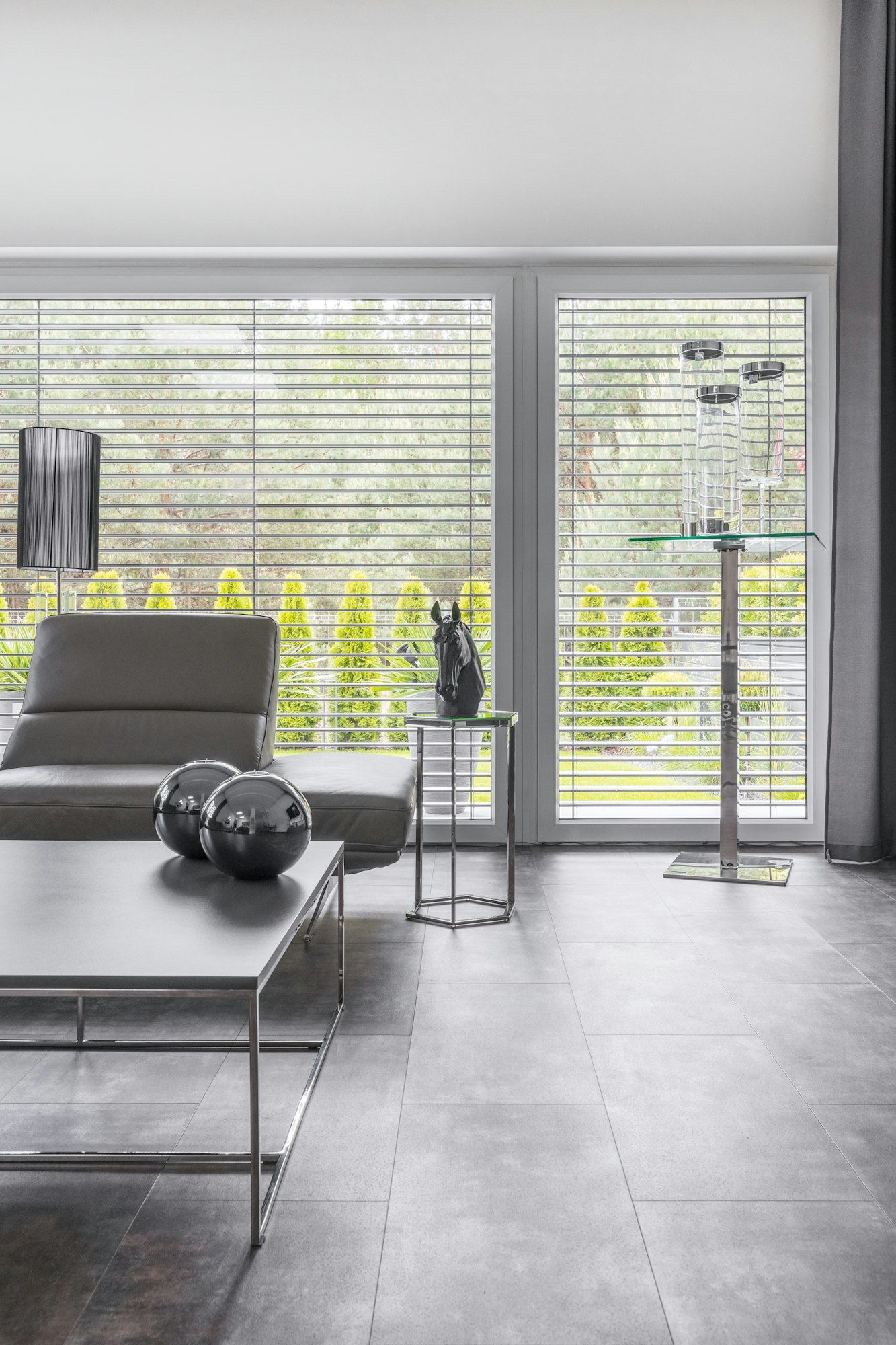 Big window in trendy grey living room interior of suburban house